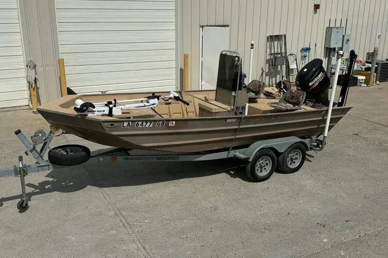 The Image of 2014 Southfork 1860 boat on trailer with Suzuki outboard motor, parked outside a building. - 0