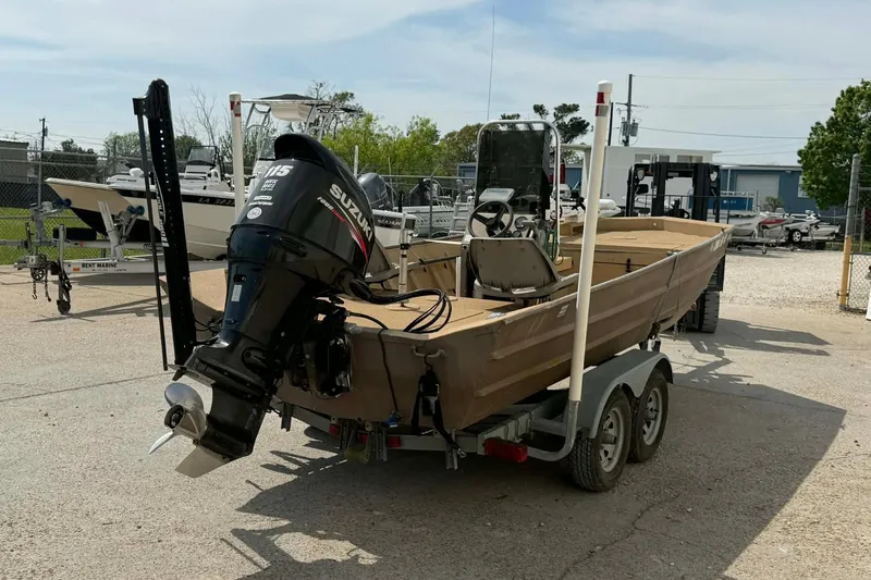 Slide: The Image of 2014 Southfork 1860 boat with Suzuki 115 outboard motor on trailer in marina setting. - 4