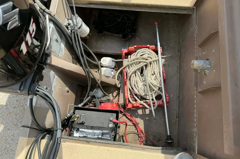 Slide: The Image of Interior of a 2014 Southfork 1860 boat showing engine, battery, and rope storage. - 5