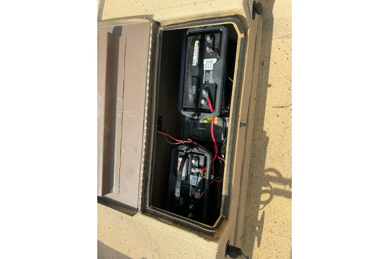 Slide: The Image of Open battery compartment of 2014 Southfork 1860 boat, showing two connected batteries. - 8
