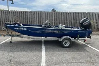 The Image of 2013 Lowe Stinger 175 boat on trailer in parking lot. - 1