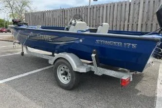 Slide: The Image of 2013 Lowe Stinger 175 boat on trailer in parking lot. - 2