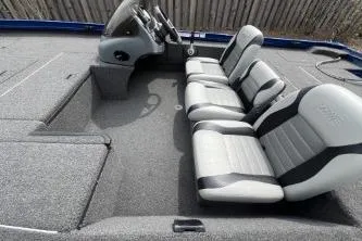 Slide: The Image of 2013 Lowe Stinger 175 boat interior with three seats and steering console. - 4