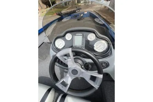Slide: The Image of 2013 Lowe Stinger 175 boat dashboard with steering wheel and gauges. - 5