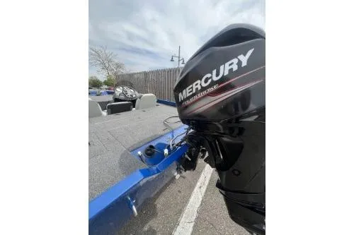 Slide: The Image of 2013 Lowe Stinger 175 boat with Mercury outboard motor, parked outdoors. - 6