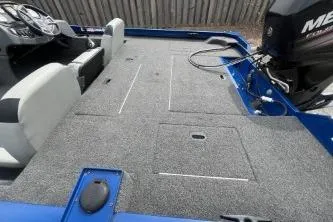 Slide: The Image of 2013 Lowe Stinger 175 boat interior with carpeted deck and Mercury engine. - 7