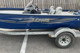 Slide: The Image of 2013 Lowe Stinger 175 boat on trailer, blue exterior, parked in lot. - 9