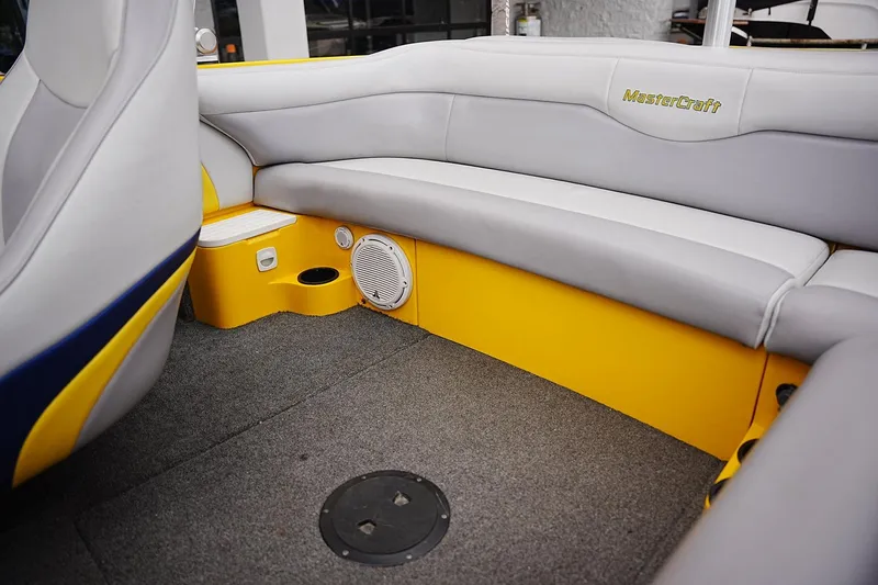 Slide: The Image of Interior of a 2007 MasterCraft X10 boat with gray and yellow seating. - 10