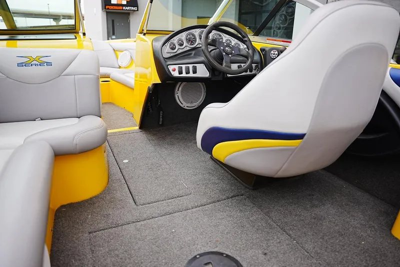 Slide: The Image of Interior of a 2007 MasterCraft X10 boat with yellow and gray seating. - 11