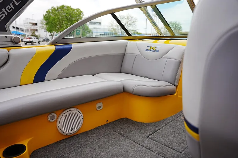 Slide: The Image of Interior of a 2007 MasterCraft X10 boat with gray and yellow seating. - 12