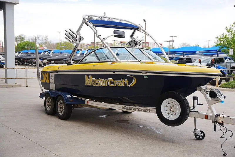 Slide: The Image of 2007 MasterCraft X10 boat on trailer, parked outdoors at a dealership. - 5