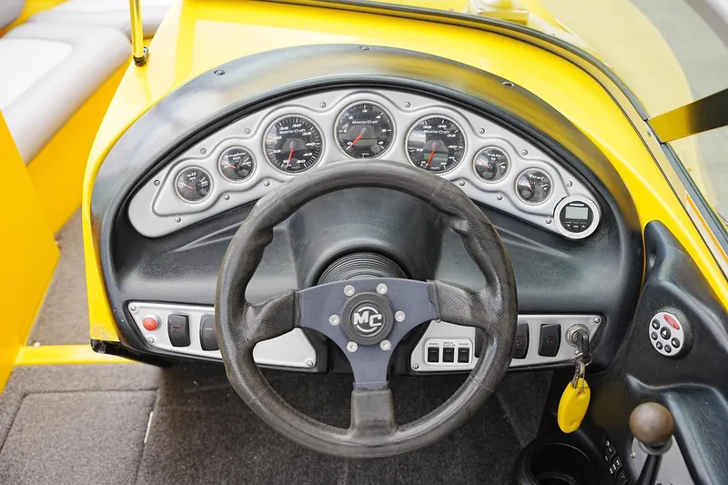 Slide: The Image of Dashboard of a 2007 MasterCraft X10 boat with steering wheel and gauges. - 9