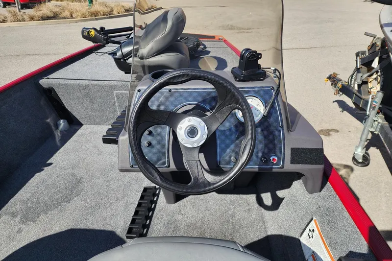 Slide: The Image of 2024 Tracker Bass Tracker Classic XL boat dashboard with steering wheel and gauges. - 4