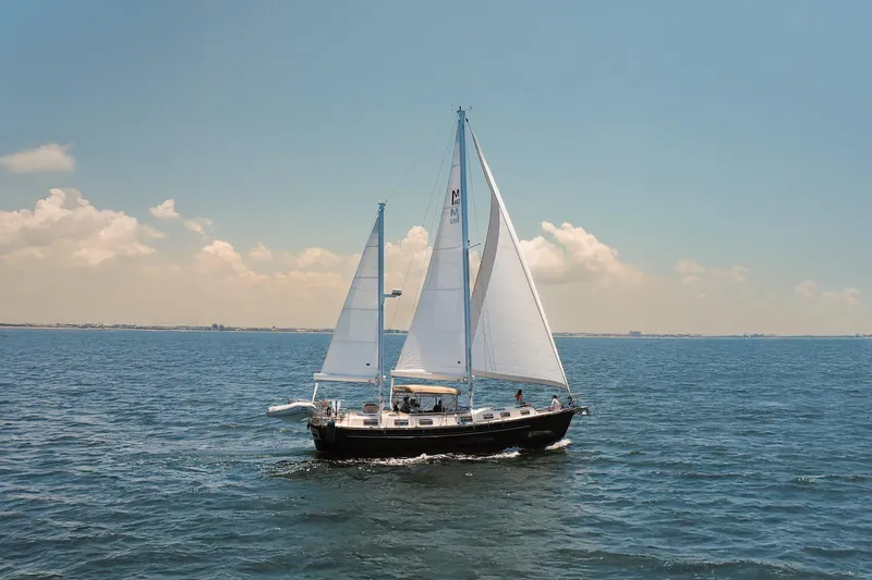 The Image of 1980 Morgan 462 sailboat cruising on open sea under clear blue sky. - 0