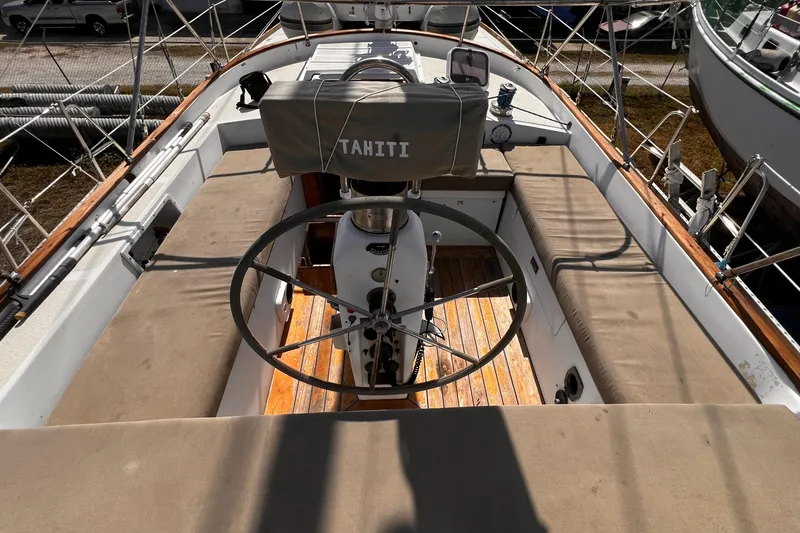 Slide: The Image of 1980 Morgan 462 sailboat cockpit with wooden deck and steering wheel, labeled "Tahiti." - 11