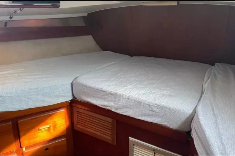 Slide: The Image of Interior cabin of 1980 Morgan 462 yacht with twin beds and wooden storage. - 18