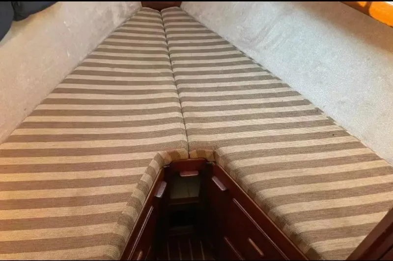 Slide: The Image of Interior view of a 1980 Morgan 462 sailboat cabin with striped cushions. - 19