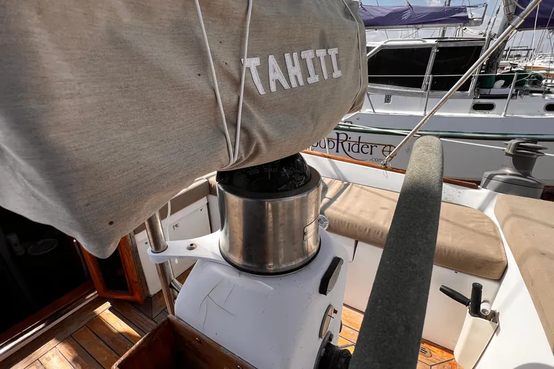 Slide: The Image of 1980 Morgan 462 sailboat cockpit with covered wheel, docked at marina. - 21