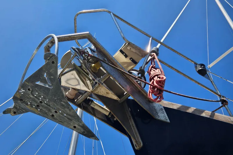 Slide: The Image of Close-up of a 1980 Morgan 462 sailboat's bow and anchor against a clear blue sky. - 27