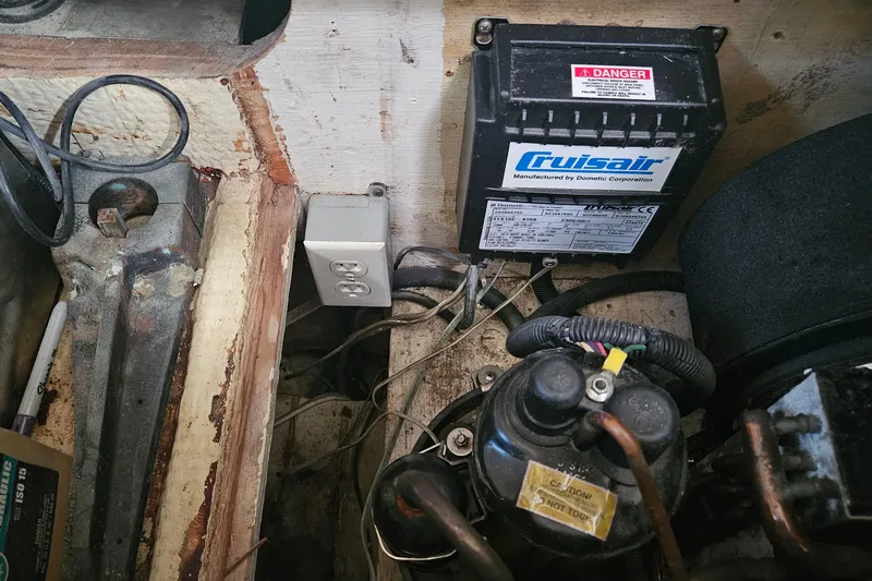 Slide: The Image of 1980 Morgan 462 boat engine compartment with Cruisair unit and electrical outlet. - 32