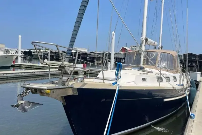 Slide: The Image of 1980 Morgan 462 sailboat docked at marina under clear blue sky. - 35
