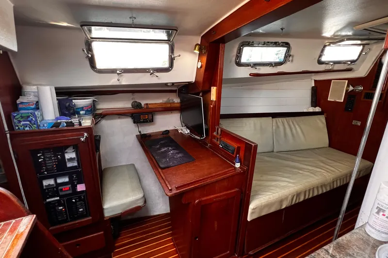 Slide: The Image of Interior of a 1980 Morgan 462 yacht with wood paneling and seating area. - 4