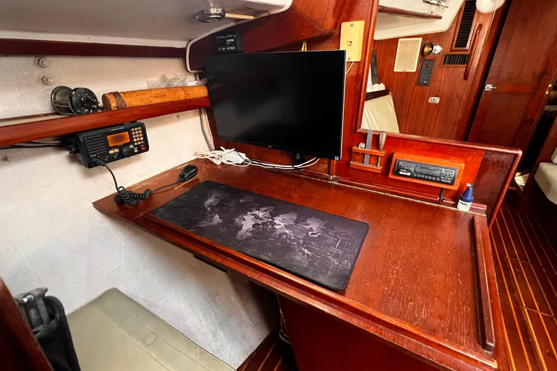 Slide: The Image of Navigation station inside a 1980 Morgan 462 sailboat with radio and monitor. - 7