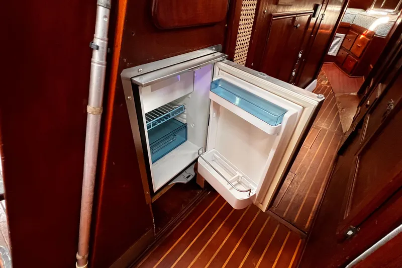 Slide: The Image of Cozy interior of a 1980 Morgan 462 sailboat with wood paneling and seating area. - 8