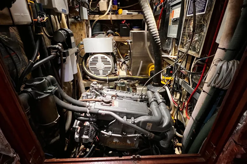 Slide: The Image of Interior of a 1980 Morgan 462 sailboat with wooden paneling and cushioned seating. - 9