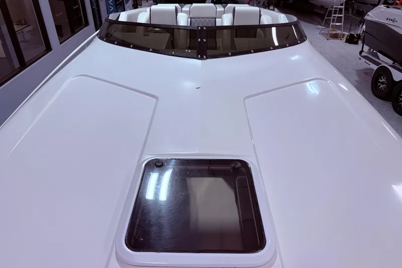 Slide: The Image of 2008 Sleekcraft 34' Heritage boat with white deck and windshield in a showroom. - 20