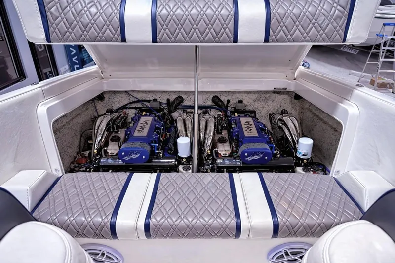 Slide: The Image of 2008 Sleekcraft 34' Heritage boat engine compartment with dual engines and quilted upholstery. - 29