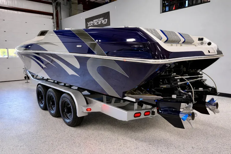 Slide: The Image of 2008 Sleekcraft 34' Heritage boat on trailer, featuring sleek blue and silver design. - 34