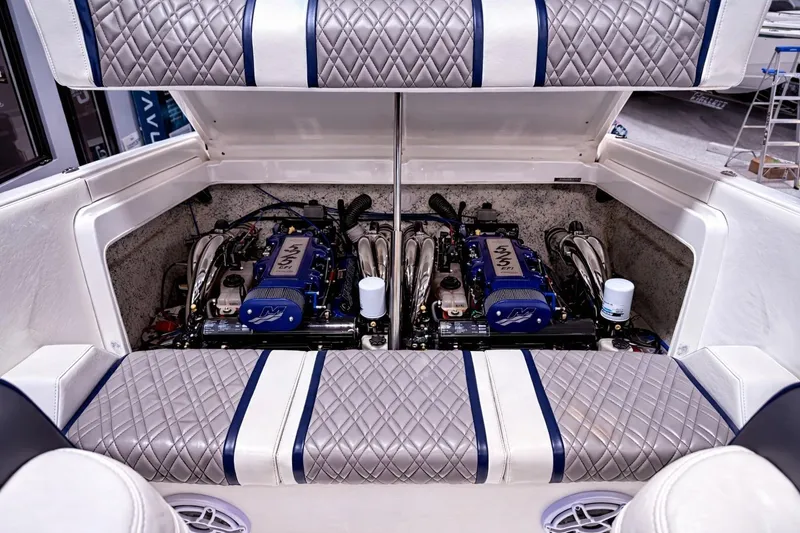Slide: The Image of 2008 Sleekcraft 34' Heritage boat engine compartment with dual engines and quilted upholstery. - 6