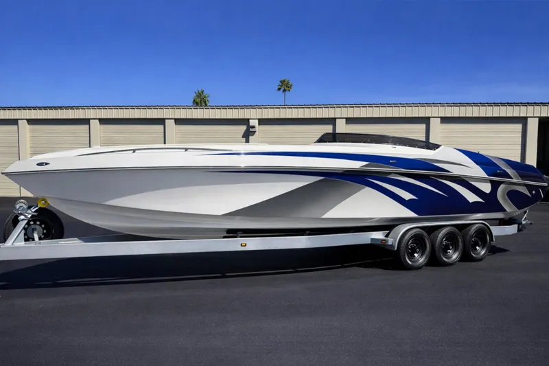 Slide: The Image of 2008 Sleekcraft 34' Heritage boat on trailer, featuring sleek blue and white design. - 11