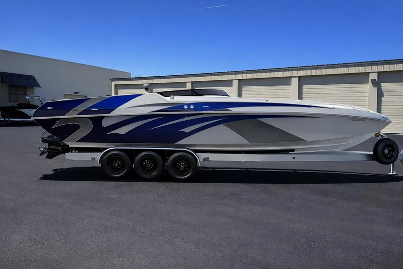 Slide: The Image of 2008 Sleekcraft 34' Heritage boat on trailer, featuring sleek blue and silver design. - 2