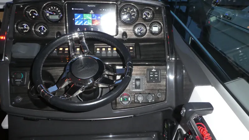 Slide: The Image of Dashboard of 2019 Monterey 295 Sport Yacht with steering wheel and instruments. - 10