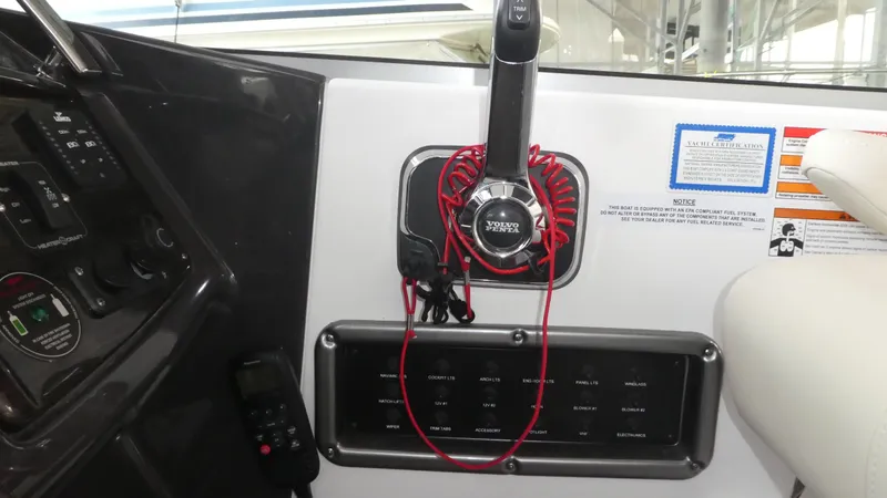 Slide: The Image of 2019 Monterey 295 Sport Yacht control panel with throttle and switches. - 11