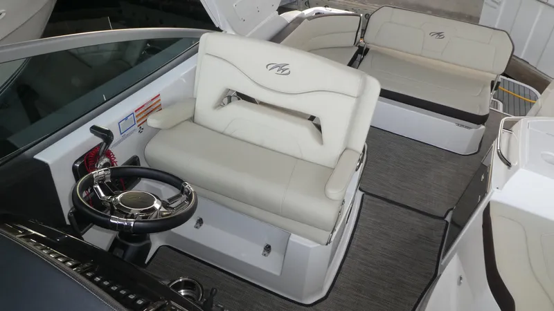 Slide: The Image of Interior of 2019 Monterey 295 Sport Yacht with steering wheel and seating area. - 12