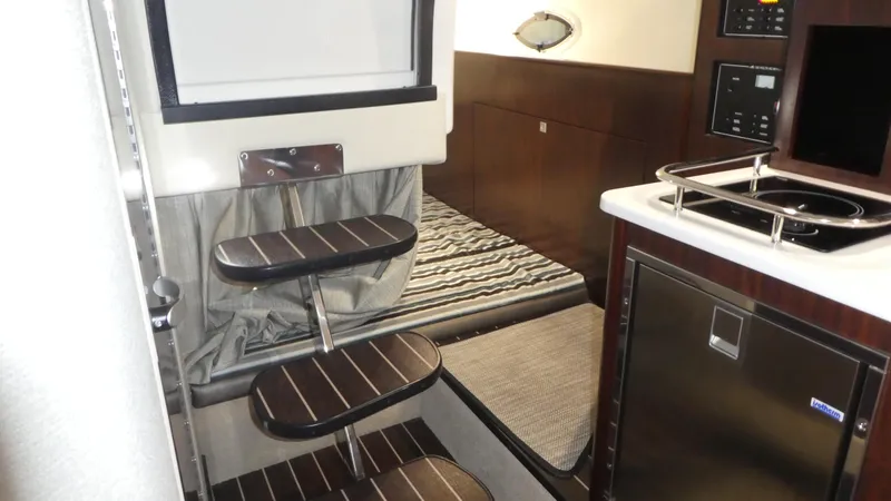 Slide: The Image of Interior of 2019 Monterey 295 Sport Yacht with kitchen and sleeping area. - 20