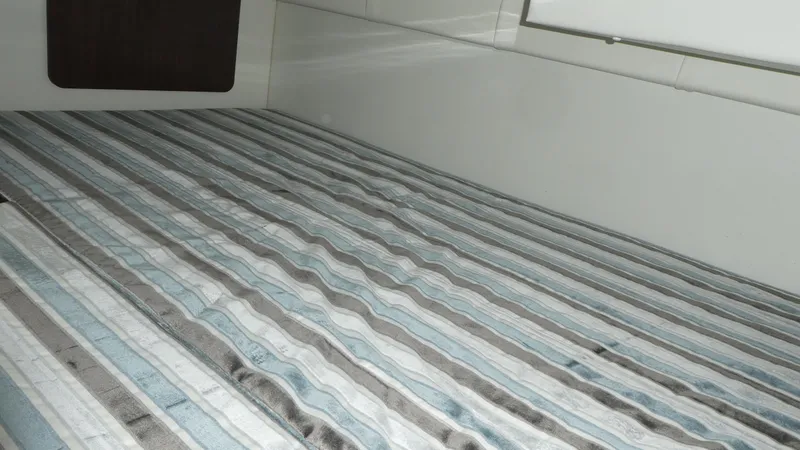 Slide: The Image of Interior of 2019 Monterey 295 Sport Yacht with striped bedding. - 21