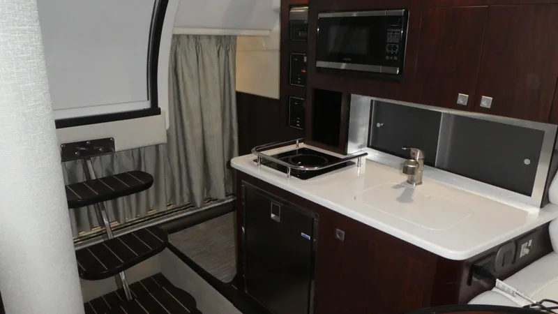 Slide: The Image of Interior of 2019 Monterey 295 Sport Yacht featuring kitchen and stairs. - 22