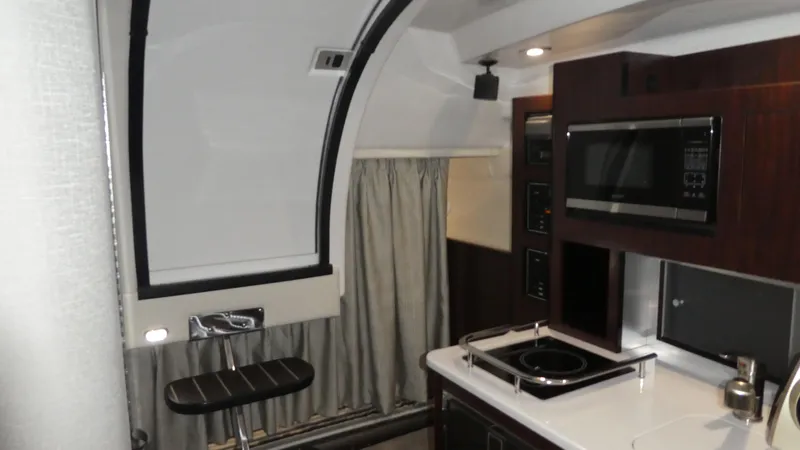 Slide: The Image of Interior of 2019 Monterey 295 Sport Yacht with modern kitchen. - 23