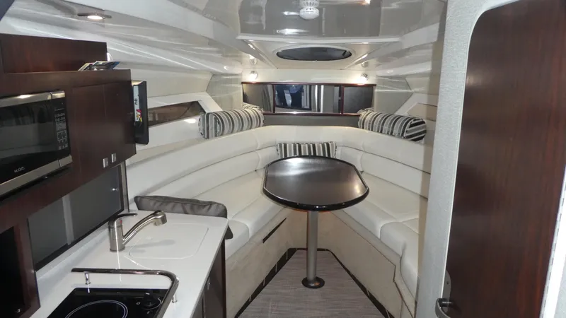 Slide: The Image of Interior of 2019 Monterey 295 Sport Yacht with kitchen and seating area. - 24