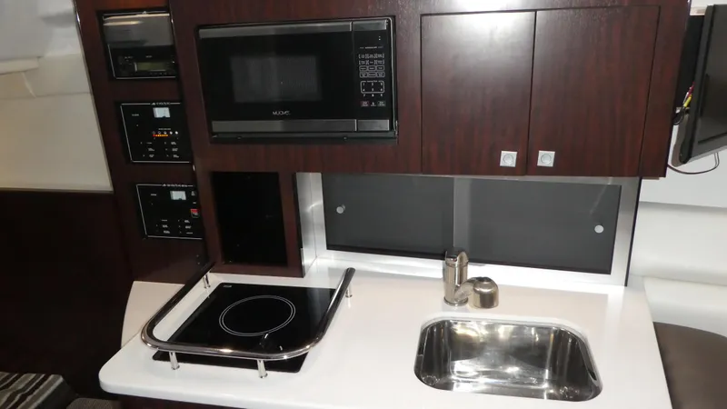 Slide: The Image of Galley in 2019 Monterey 295 Sport Yacht with microwave and sink. - 31
