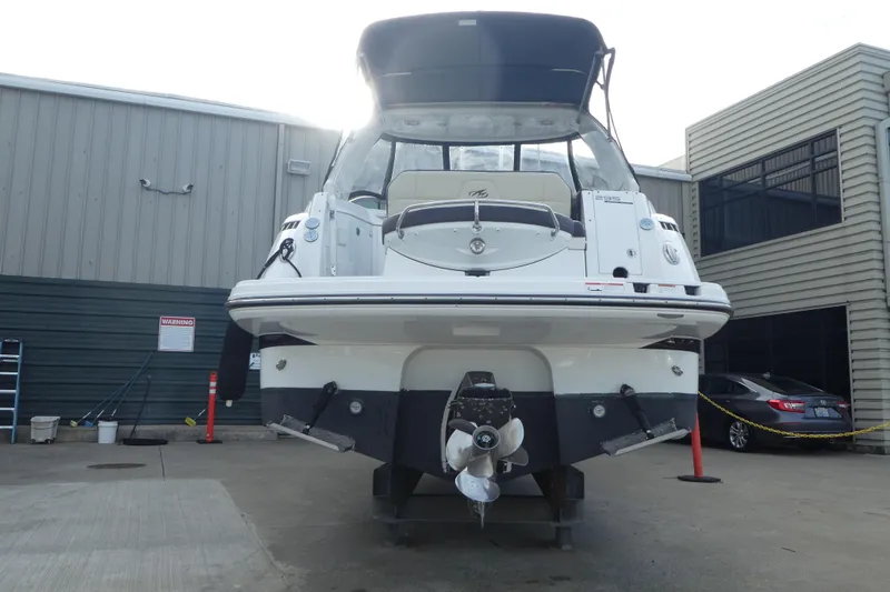 Slide: The Image of 2019 Monterey 295 Sport Yacht in a marina, rear view with propeller visible. - 73