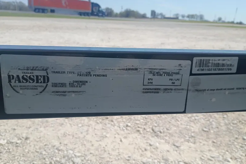 Slide: The Image of Sticker on a 2007 Tracker Pro Team 175 trailer, indicating inspection passed. - 13