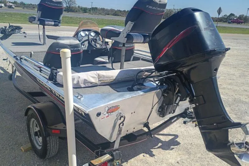 Slide: The Image of 2007 Tracker Pro Team 175 boat with motor and trailer in a parking area. - 8