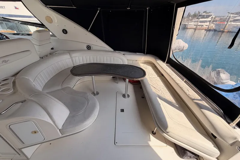 Slide: The Image of Luxurious 1996 Sea Ray 450 Sundancer yacht interior with white seating and table. - 11