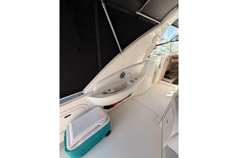 Slide: The Image of Interior view of 1996 Sea Ray 450 Sundancer yacht with cooler and seating area. - 12