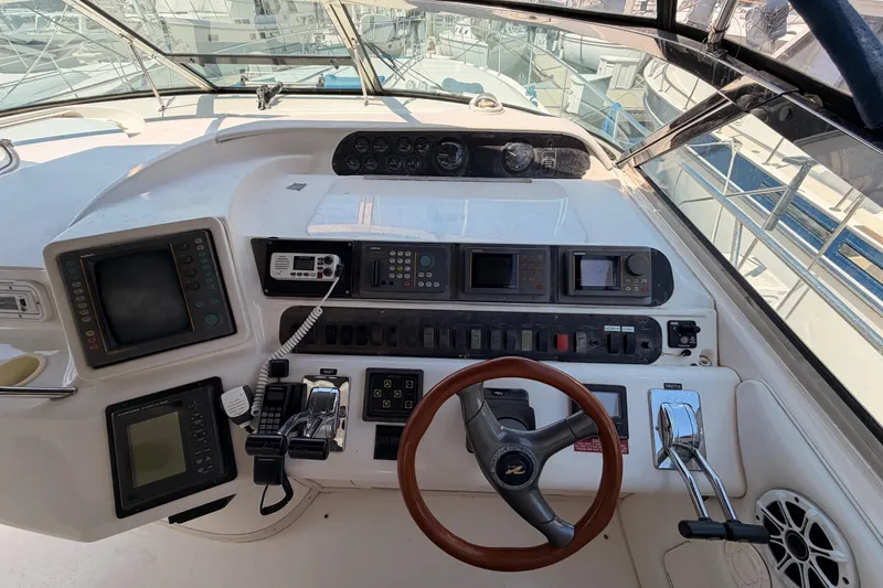 Slide: The Image of Cockpit of 1996 Sea Ray 450 Sundancer with navigation instruments and steering wheel. - 15